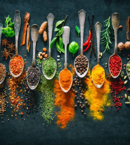 Colourful various herbs and spices for cooking on dark background